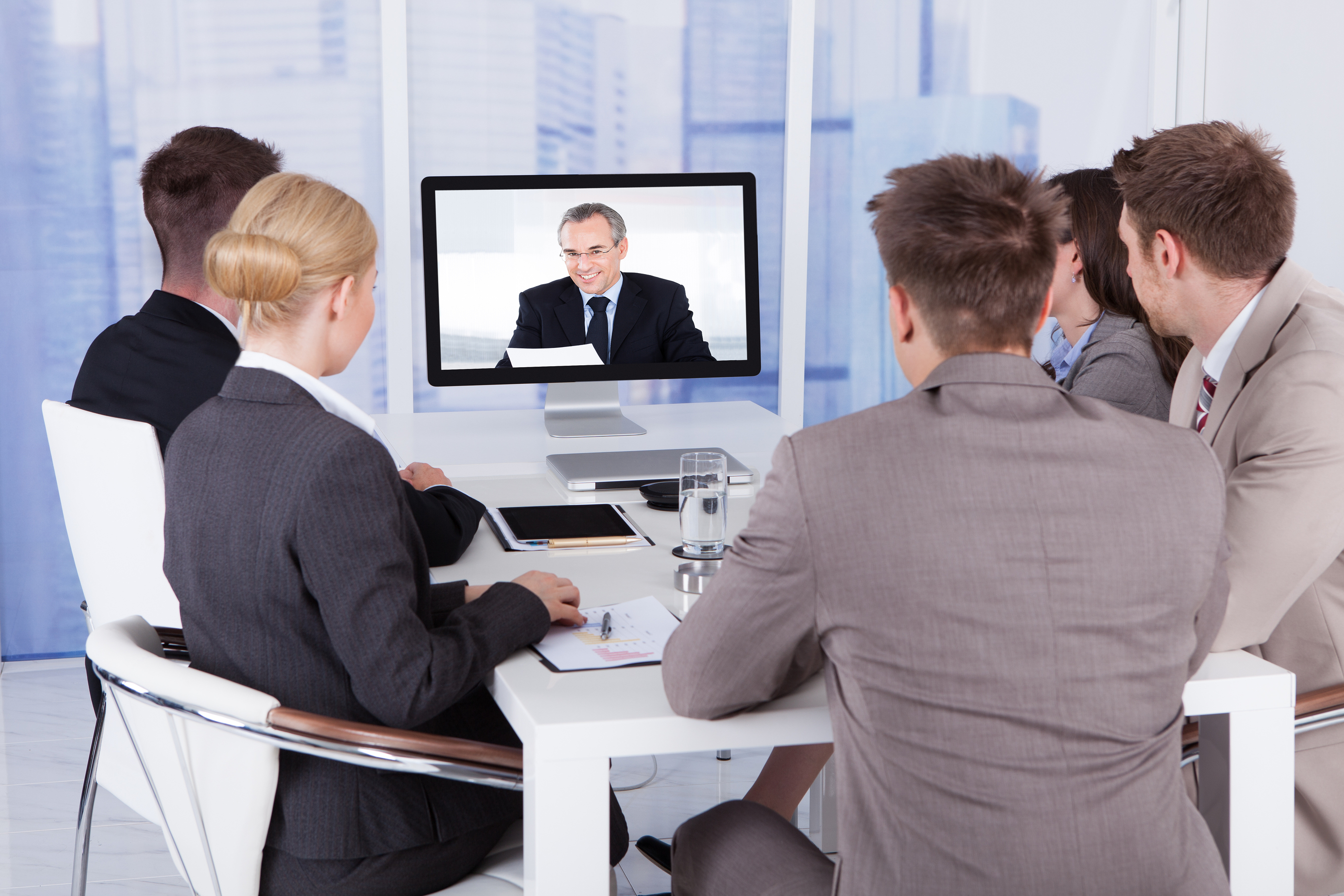 Business People In Video Conference At Table